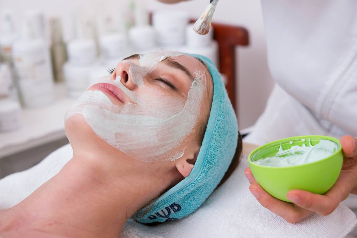 woman applying cosmetics skin solutions vitamin c serum to arms for radiant skin