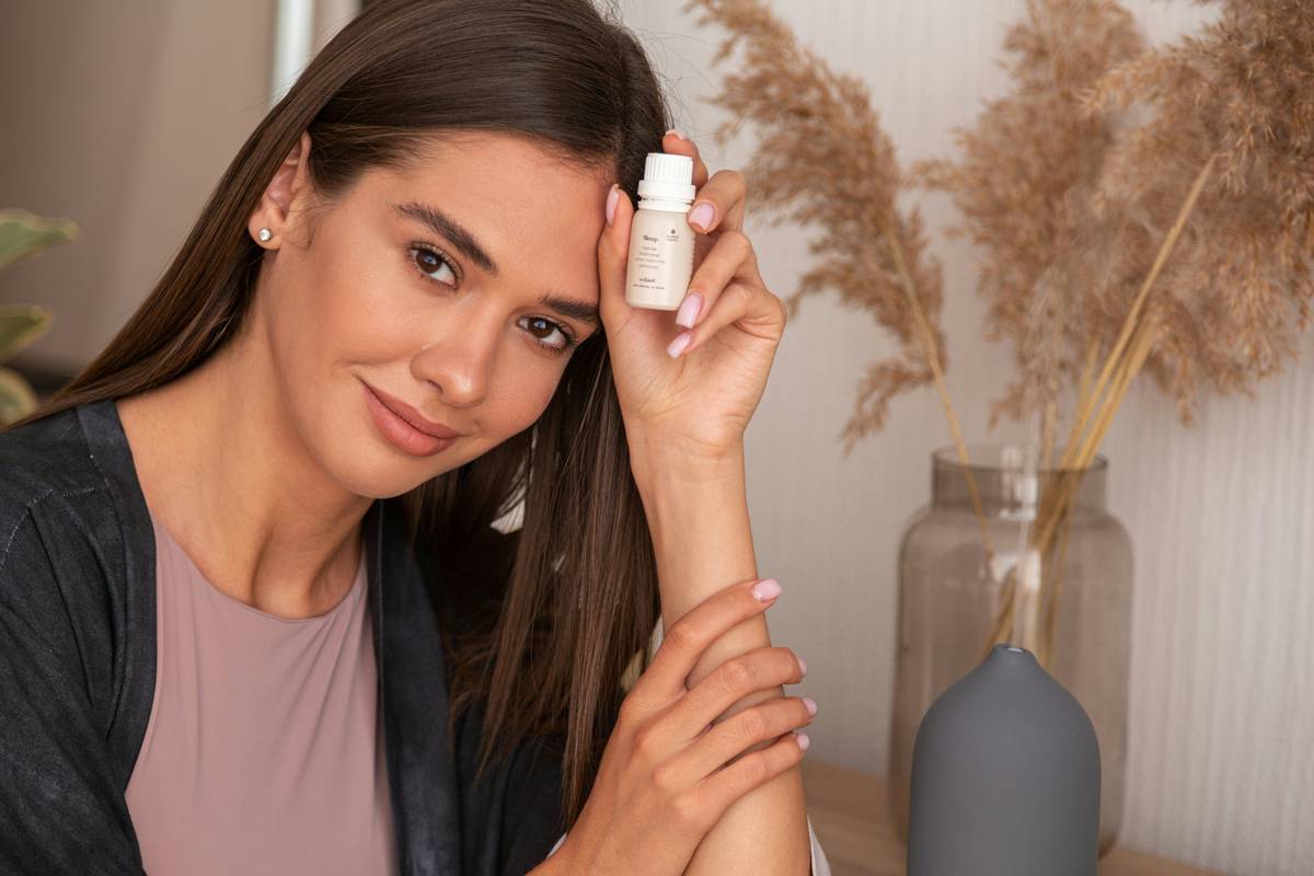 Woman applying skin vitamin c serum with dropper in morning routine